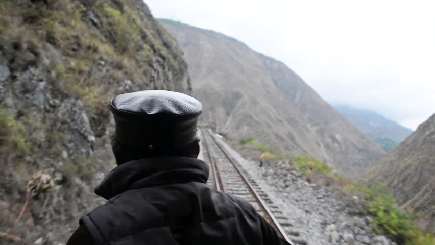 Man and train tracks in fast motion near Alausi, Ecuador