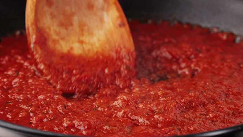 Classic homemade Italian tomato sauce with basil for pasta and pizza in the pan. Chef cooking traditional Italian food. Royalty-Free Stock Footage #1101114803