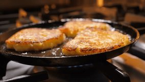 Fry potato pancakes on a pan. Draniki. Golden potato pancakes frying on a pan.