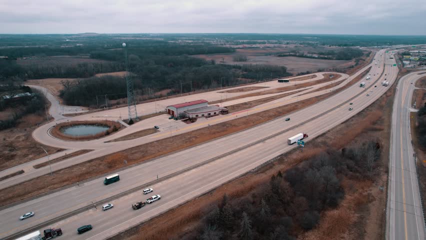 Dryvans, Flatbeds, Reefers truck drivers bypassing a Weigh Station next to Interstate. Department of Trasportation place where they pull bad drivers for safety inspection. Wisconsin, USA 4k