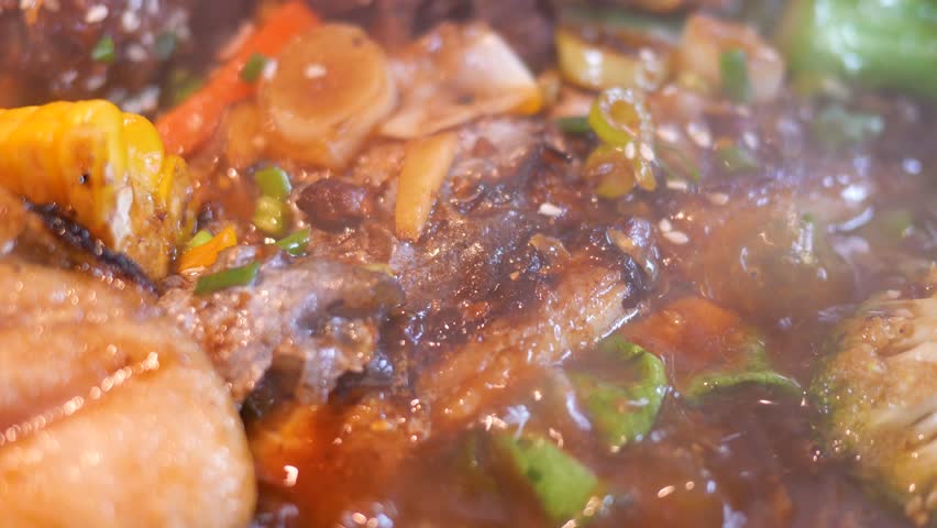 Fish simmering in a hot soup Royalty-Free Stock Footage #1101126307