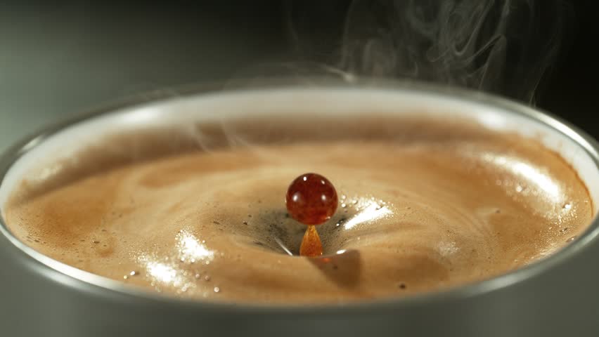 Super slow motion of falling drop into coffee with camera motion. Filmed on high speed cinema camera, 1000fps placed on high speed cine bot. Speed ramp effect. | Shutterstock HD Video #1101126337