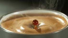 Super slow motion of falling drop into coffee with camera motion. Filmed on high speed cinema camera, 1000fps placed on high speed cine bot. Speed ramp effect. - Powered by Shutterstock - Get 15% off with code: PIKWIZARD15