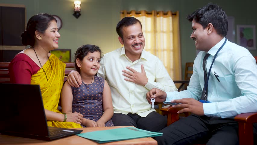 Happy smiling couple with kid receiving new home keys from banker after contract or deal at home - concept of mortgage, property investment and doorstep banking service Royalty-Free Stock Footage #1101128807
