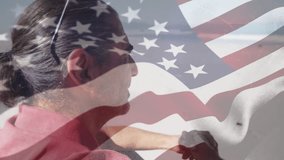 Animation of senior biracial man at beach over flag of usa. Patriotism and vacation concept digitally generated video.