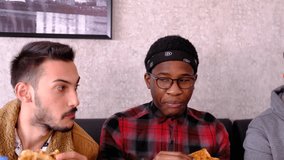 African young man and white man sitting side by side eating burritos, close-up view of young people eating by watching their surroundings - Powered by Shutterstock - Get 15% off with code: PIKWIZARD15