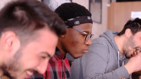 White man eating dinner telling his african friend and white friend something and making them laugh, clear view of african man with glasses - Powered by Shutterstock - Get 15% off with code: PIKWIZARD15