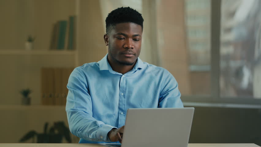 Tired sad angry African American man businessman manager entrepreneur working with laptop at office has computer problem broken device send wrong email message bad news or crash mistake error failure Royalty-Free Stock Footage #1101131143