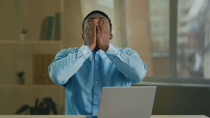 Tired sad angry African American man businessman manager entrepreneur working with laptop at office has computer problem broken device send wrong email message bad news or crash mistake error failure Royalty-Free Stock Footage #1101131143