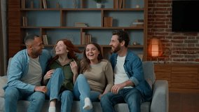 Diverse ethnic group of best friends african american hispanic caucasian people gathering together jumping on couch multiracial men women sit on sofa laughing give high five meeting at home weekend - Powered by Shutterstock - Get 15% off with code: PIKWIZARD15