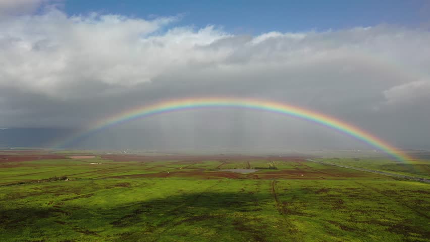 Maui, hawaii - circa 2022 - excellent aerial footage of a rainbow spanning a field in maui. Royalty-Free Stock Footage #1101133141