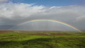 Maui, hawaii - circa 2022 - excellent aerial footage of a rainbow spanning a field in maui.
