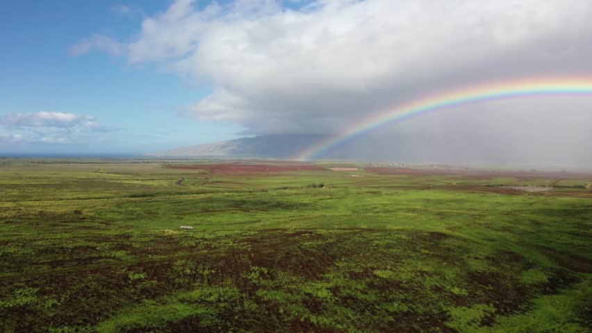 Maui, hawaii - circa 2022 - excellent aerial footage of half of rainbow over a field in maui. Royalty-Free Stock Footage #1101133505