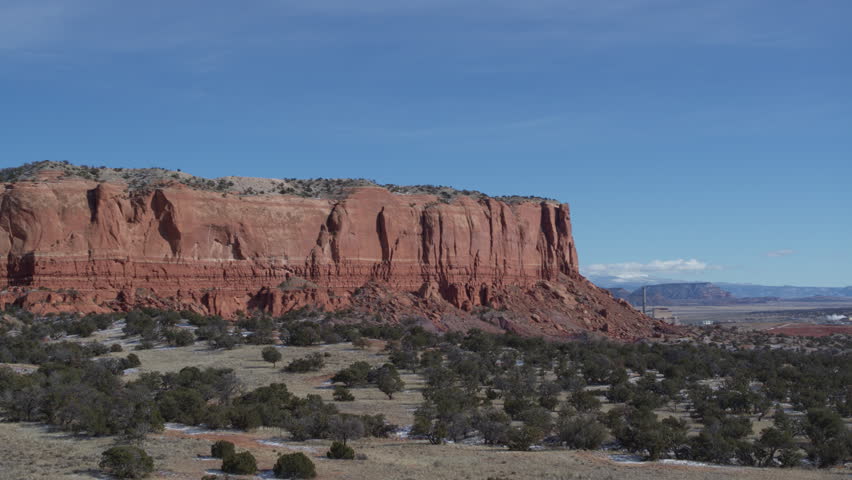 Aerial of New Mexico red rock landscape with sandstone mesa in winter