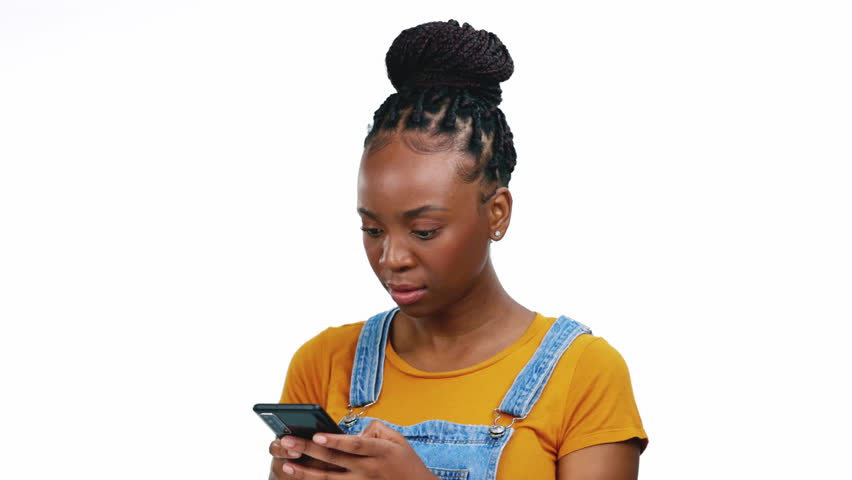 Black woman, studio and angry with phone, texting and rage for cheating, social media and isolated shouting. Gen z girl, break smartphone and frustrated for glitch, website or app by white background Royalty-Free Stock Footage #1101137093