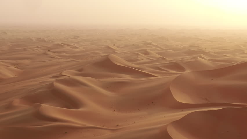 Drone shot bedouin man walking on dunes in desert | Shutterstock HD Video #1101137637