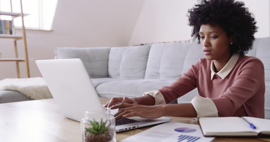 Remote workers are on the rise. 4k footage of an attractive young woman using a laptop while working at home. | Shutterstock HD Video #1101145153