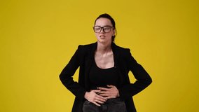 4k video of one girl with negative facial expression over yellow background.