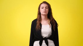 4k slow motion video of one girl in panic on yellow background.