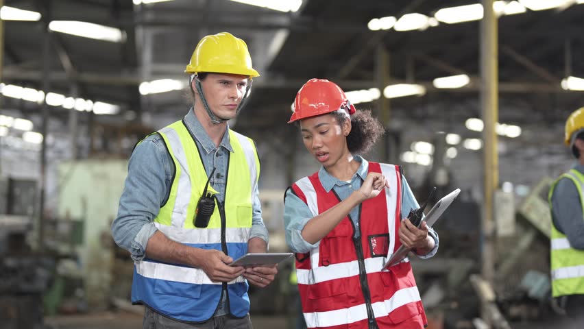 Factory worker people inspecting.women and African woman people talking in front of heavy machines at industry factory. Engineer Operating and control. Team of man operating on site inspection. | Shutterstock HD Video #1101148181