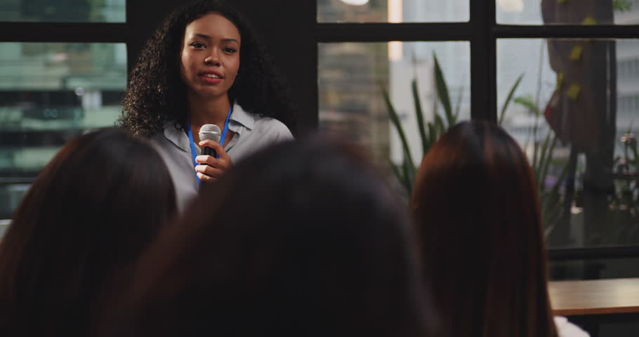 Confident young businesswoman or speaker sharing ideas with colleagues or audience during company seminar. Royalty-Free Stock Footage #1101148533