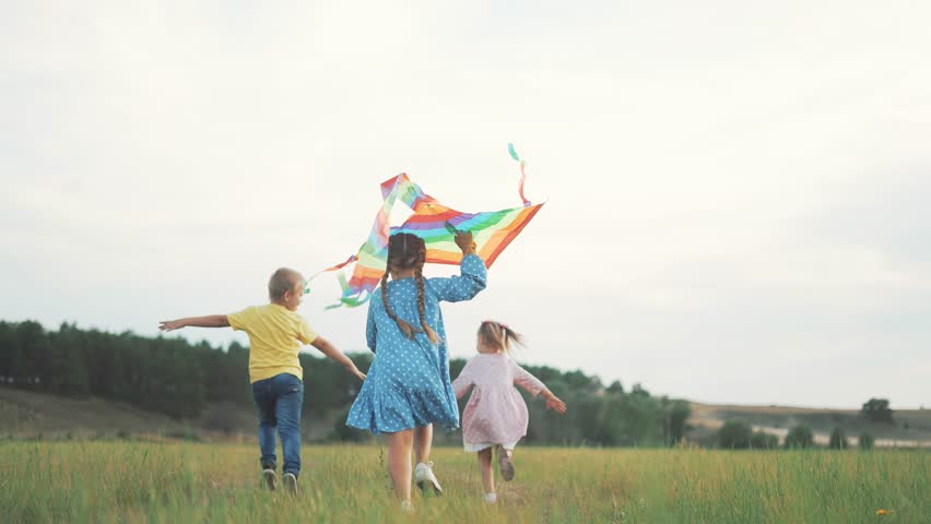 Launch of happiness. Healthy and playful family life with kites. a happy and healthy family spends the weekend outdoors running and playing with kites. The child launches colorful kites into the sky. | Shutterstock HD Video #1101151055