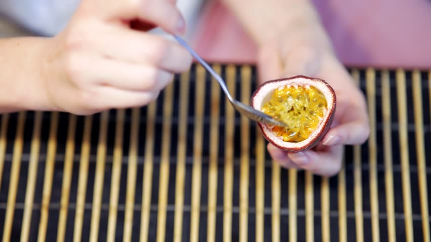 Eating Fresh Purple Passion Fruit With Spoon. Delicious Healthy Food. Organic Tropical Fruits. Scooping Inside Of Passion Fruit. Raw Vitamin Juice. Granadilla On Pasion Fruit And Seed. Summer Maracuja