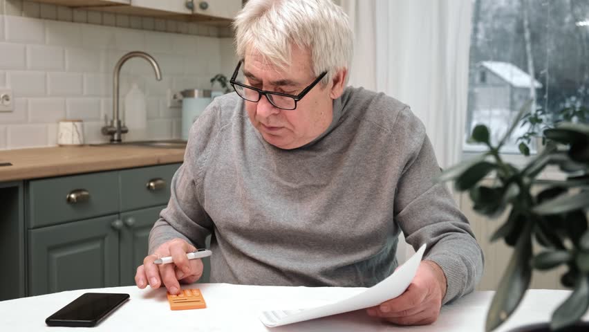 Senior Man Checking Calculating Personal Finance at Home, Feeling Stress from Money Problem. Concerned Elderly Male get Official Bank Notification, Financial Bill, Unpaid Debt or Tax and Feel Worried | Shutterstock HD Video #1101152901