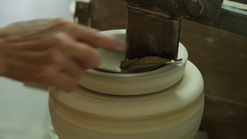 Close up of a woman working on a potter s wheel making clay. | Shutterstock HD Video #1101157013