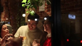 a pub with a group of diverse friends, through the glass you can see how they have fun drinking beer. - Powered by Shutterstock - Get 15% off with code: PIKWIZARD15