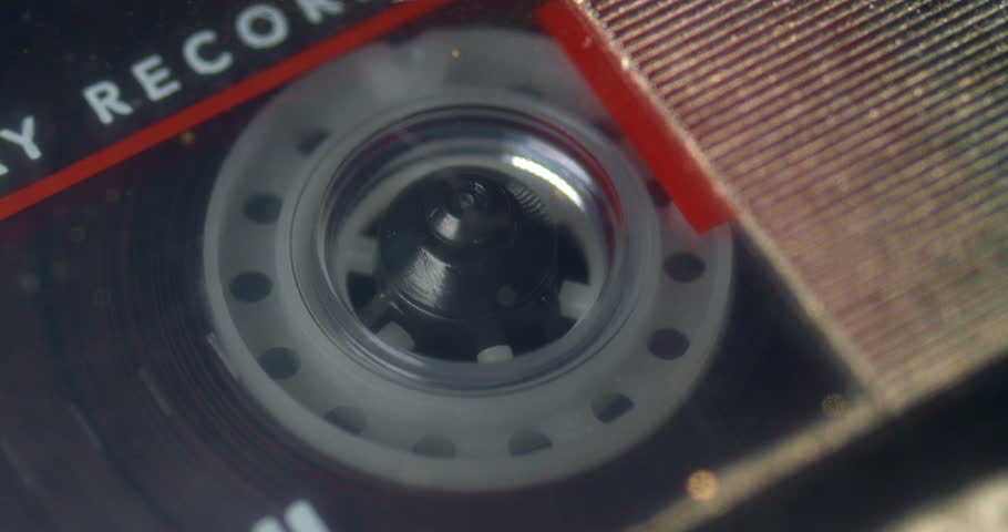 Macro close up of audio cassette tape playing, stoping, Fast Forwarding and Rewinding in old vintage mechanical, analog tape recorder. Royalty-Free Stock Footage #1101171355