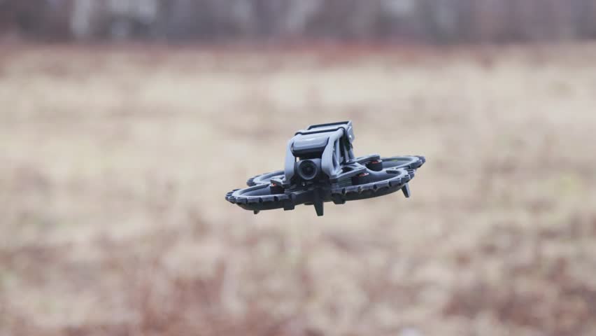 The drone flies in a circle and flies past the operator.
