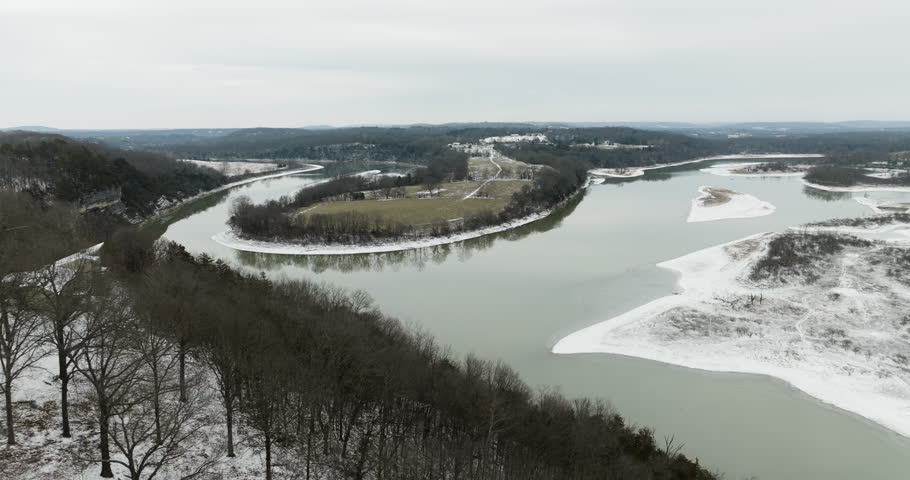 Harmonious Ozarks scenery - a lake frozen in stillness and dormant woodland.