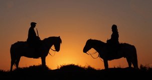 Man and Woman on a Camargue or Camarguais Horse in the Dunes at Sunrise, Manadier in the Camargue in the South East of France, Les Saintes Maries de la Mer, Real Time 4K