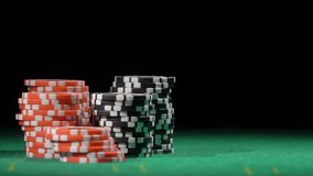 Game of dice. Gambling in the casino. Throws red dice, slow motion. Red and black chip stacks on a green gaming table. Betting. Fortune, risk and win. - Powered by Shutterstock - Get 15% off with code: PIKWIZARD15