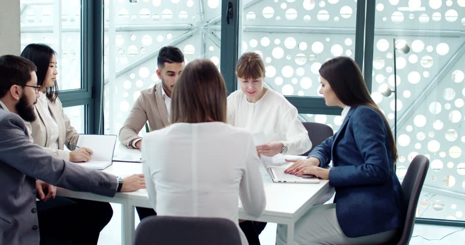 Team work of productive creative cooperation of beautiful smart people working in modern company office. Effective attractive young people wearing suits brainstorming ideas for development. | Shutterstock HD Video #1101186769