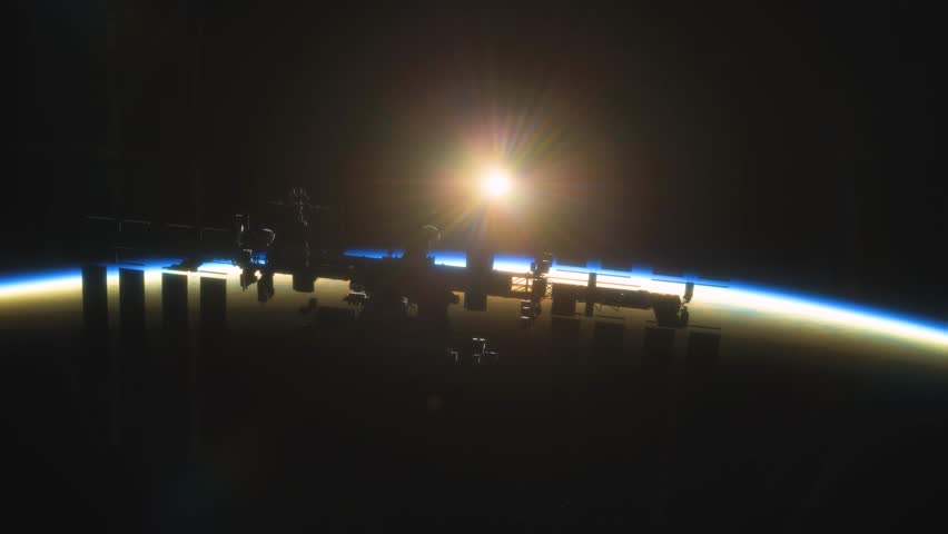 International Space Station ISS Floating in Orbit above Planet Earth in outer space. Sunrise or sunset view from space | Shutterstock HD Video #1101188679