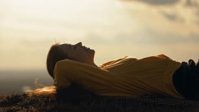 
Natural beauty attractive woman lies on the grass on the mountain in the sunshine and smiles strongly, enjoying the spring sun and the nature of the countryside. Rest and travel - Powered by Shutterstock - Get 15% off with code: PIKWIZARD15