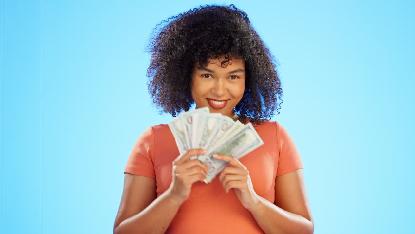 Face, dollars and woman with money fan dancing in studio isolated on a blue background. Financial winner, wealth wink and portrait of happy, rich or excited female dance with cash after winning prize | Shutterstock HD Video #1101190737