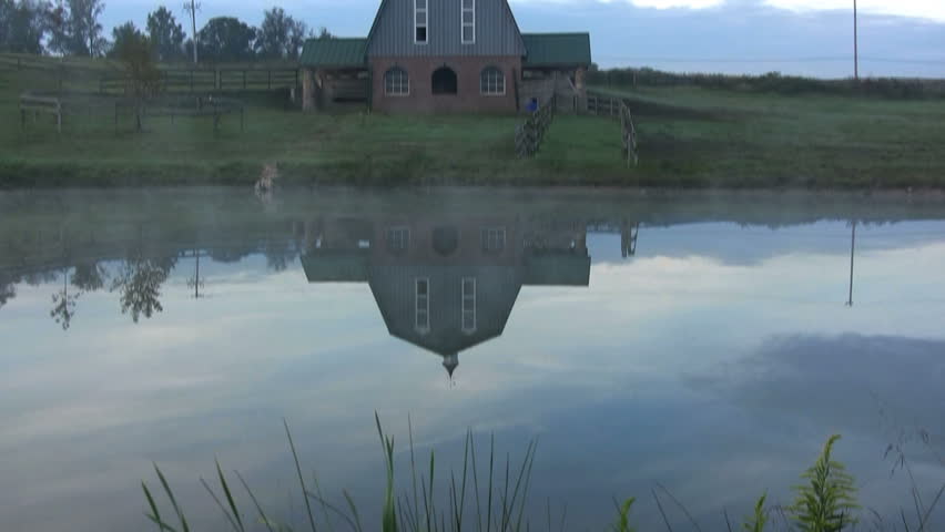Reflection of a barn in the water.