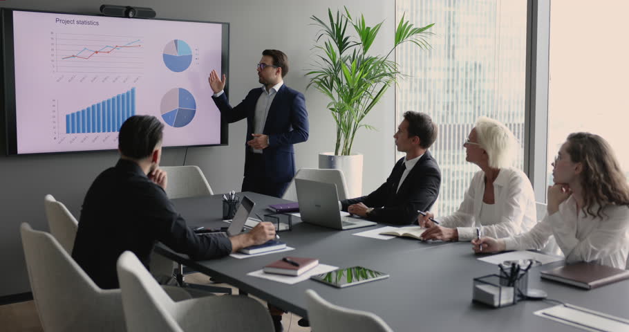 Business trainer, corporate coach or company boss make presentation for partners, clients or staff pointing on TV screen, showing diagrams, charts with statistics data during conference in boardroom Royalty-Free Stock Footage #1101193081