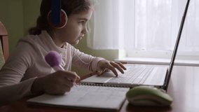 School Student Wearing Headphones Watching Internet Video Course. Distance Learning. Schoolgirl Studying Online Using Laptop Making Notes in Copybook. Caucasian Girl Wear Headphones Learn Online Class - Powered by Shutterstock - Get 15% off with code: PIKWIZARD15