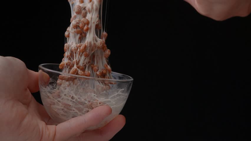 4K slow motion video to check the stickiness of natto (fermented soybeans) | Shutterstock HD Video #1101194719