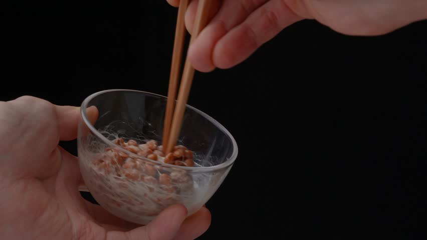 4K slow motion video of natto (fermented soybeans) well mixed to check consistency Royalty-Free Stock Footage #1101194723