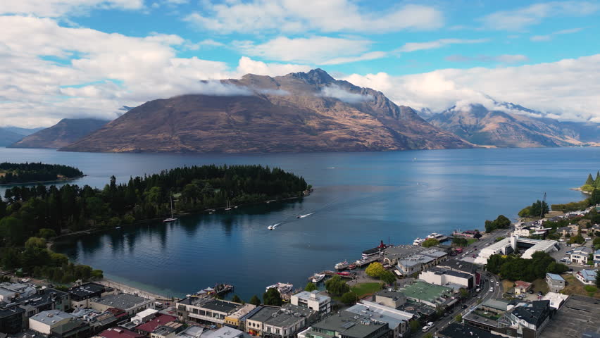 Aerial drone epic view of Queenstown in shores of Wakatipu lake and mountains in background Royalty-Free Stock Footage #1101204459