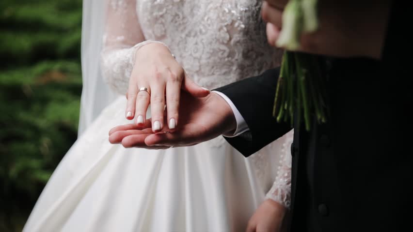 Close up of wedding couple holding hands shot in slow motion Love, marriage, bride, beautiful, celebration, romantic, husband, happy, female, couple, ceremony, woman, white dress Royalty-Free Stock Footage #1101207527