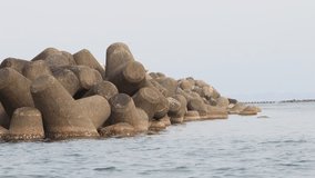 Calm sea and offshore tetrapods 4K motion background at 24fps - Powered by Shutterstock - Get 15% off with code: PIKWIZARD15