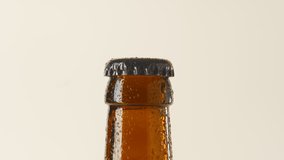 Camera is moving towards slow rotating wet, brownisch beer bottleneck. Close-up Shot. 4K. Macro. - Powered by Shutterstock - Get 15% off with code: PIKWIZARD15