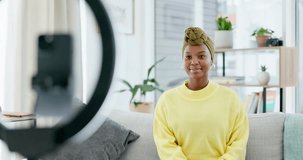 Video podcast, social media influencer and black woman with ring light talking on a sofa. Excited digital communication, greeting and phone streaming online for web audience in a home living room