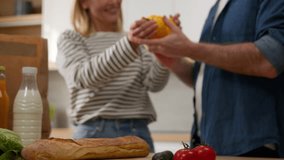 Caucasian middle-aged family senior couple adult wife and husband woman and man talking unpack delivered paper bag with food vegetables order home kitchen online supermarket shopping service hugging - Powered by Shutterstock - Get 15% off with code: PIKWIZARD15